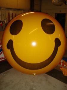 yeloow color helium balloon with smiley face artwork